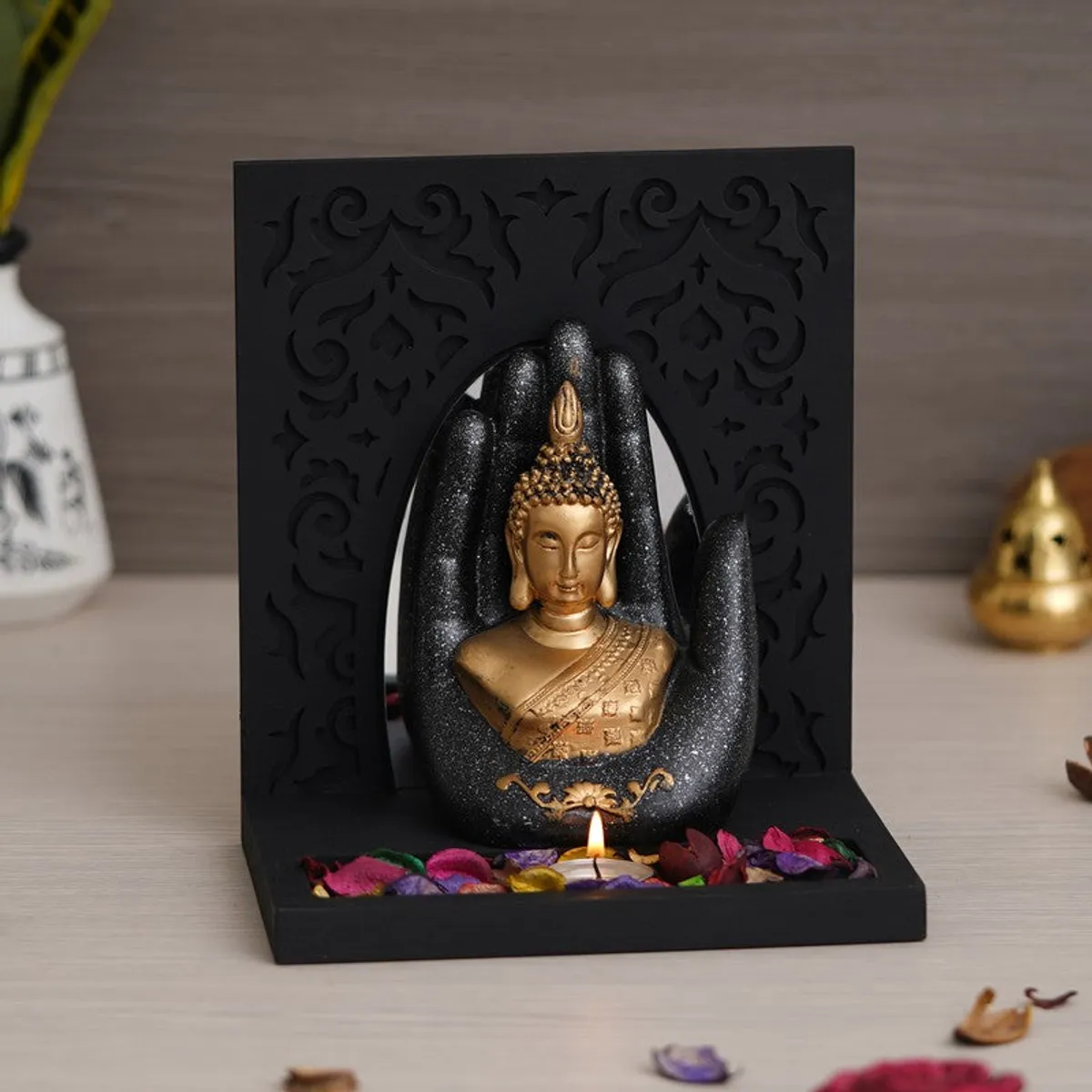 Front view of black and gold Buddha tea light candle holder