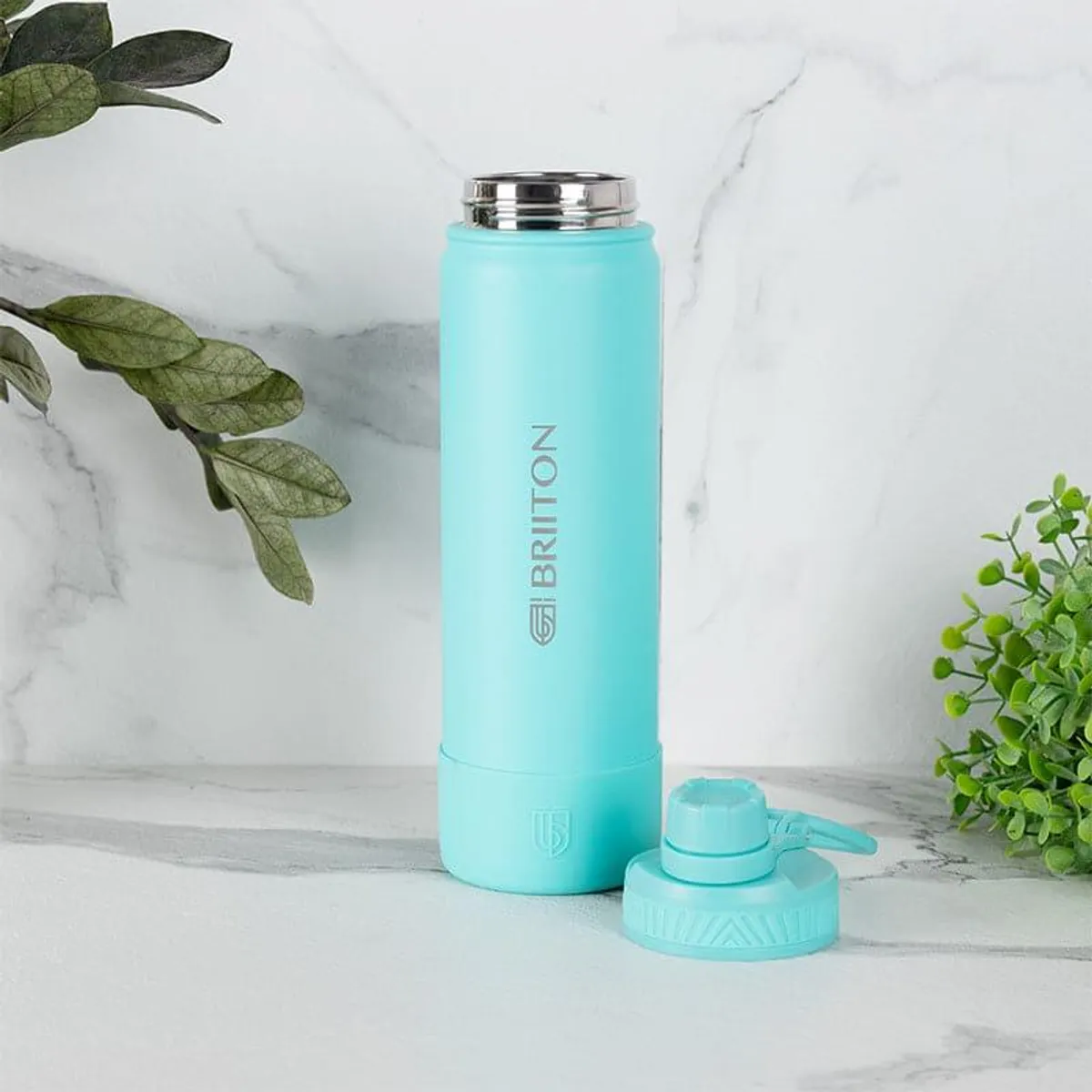 Sky-blue insulated bottle with its alternate lid placed beside it