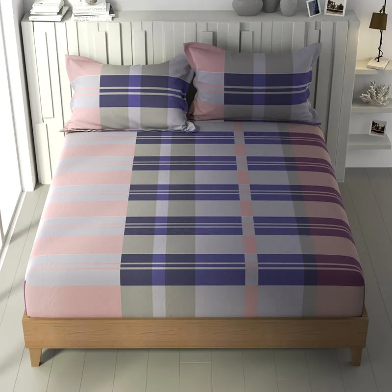 Queen bed dressed in a purple, peach and grey geometric bedsheet