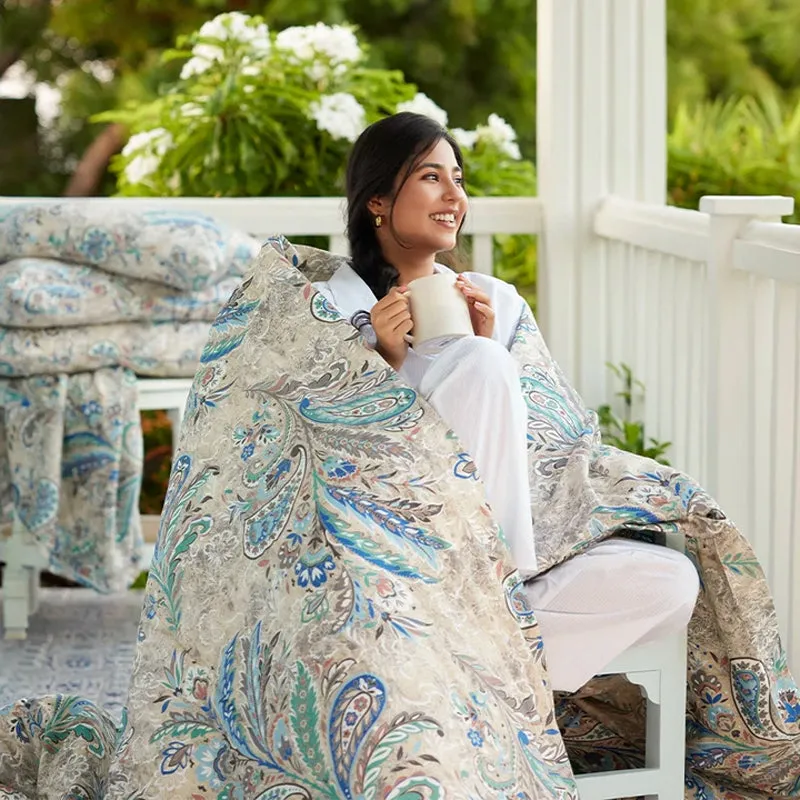 Woman wrapped in the blue and beige paisley duvet cover outdoors