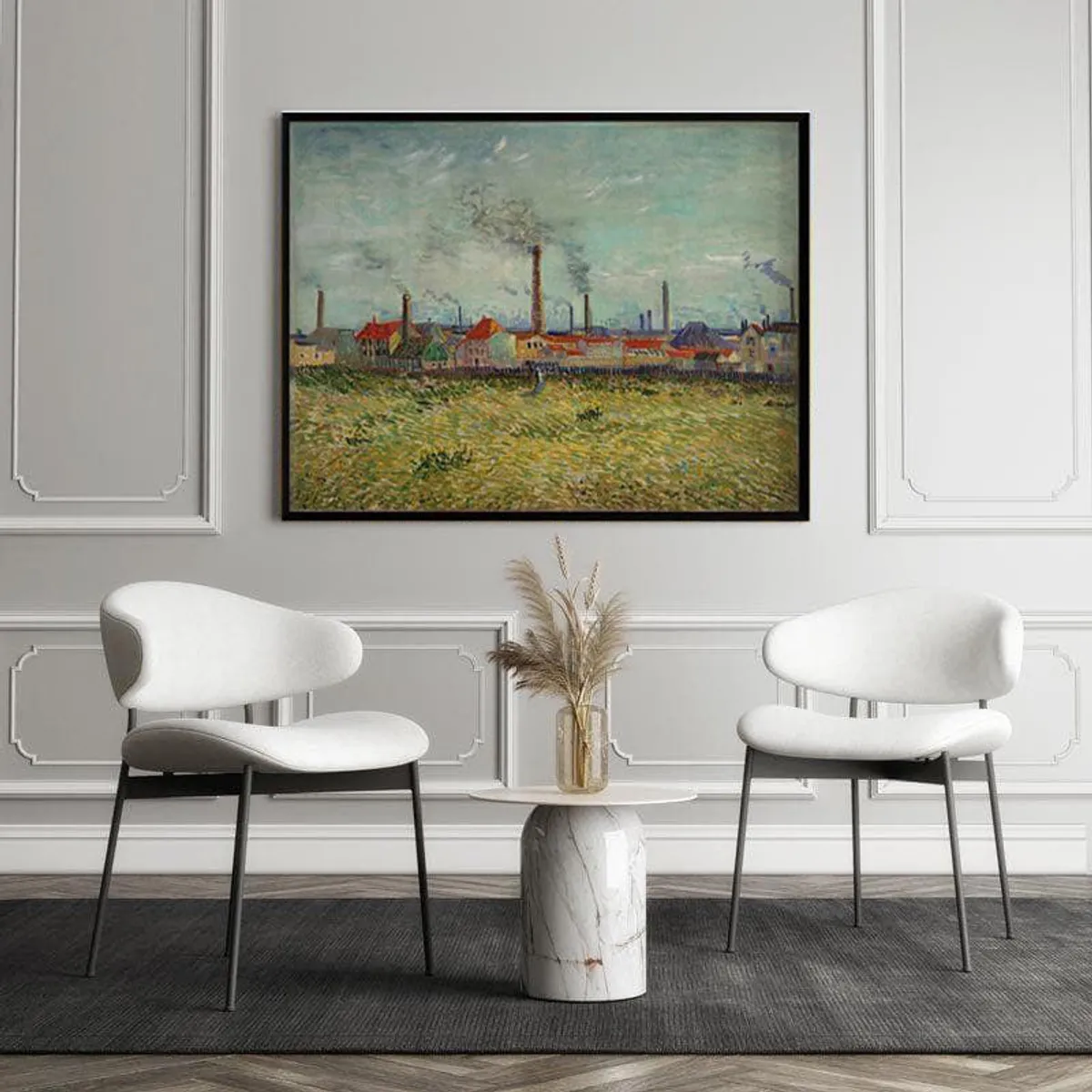 Framed landscape painting displayed above two white chairs and a marble side table.