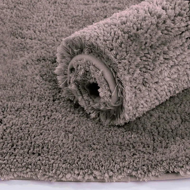 Close-up of a rolled grey shaggy runner rug showing plush texture