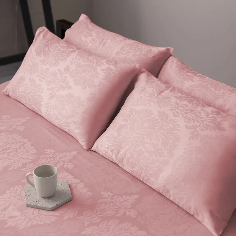 Close view of the pink floral duvet cover and matching pillows on a bed.