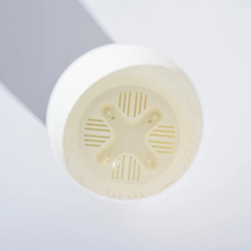 Bottom view of a white planter showing the drainage base