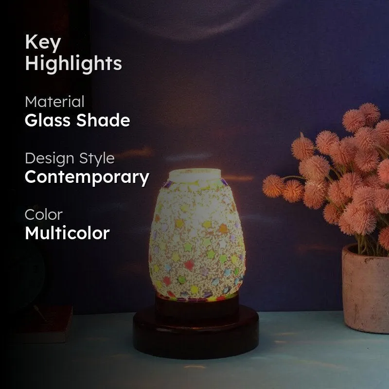 Lit multicolour star-patterned table lamp styled on a tabletop in a room setting.