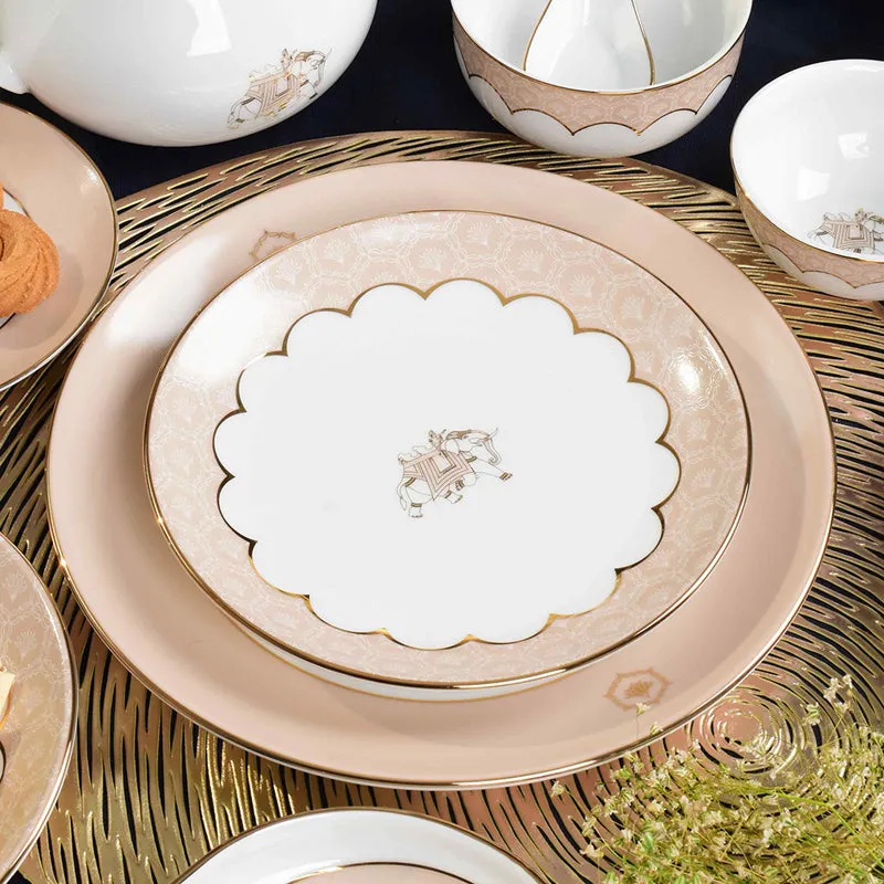 Peach and ivory dinner plates with scalloped detailing and elephant motifs