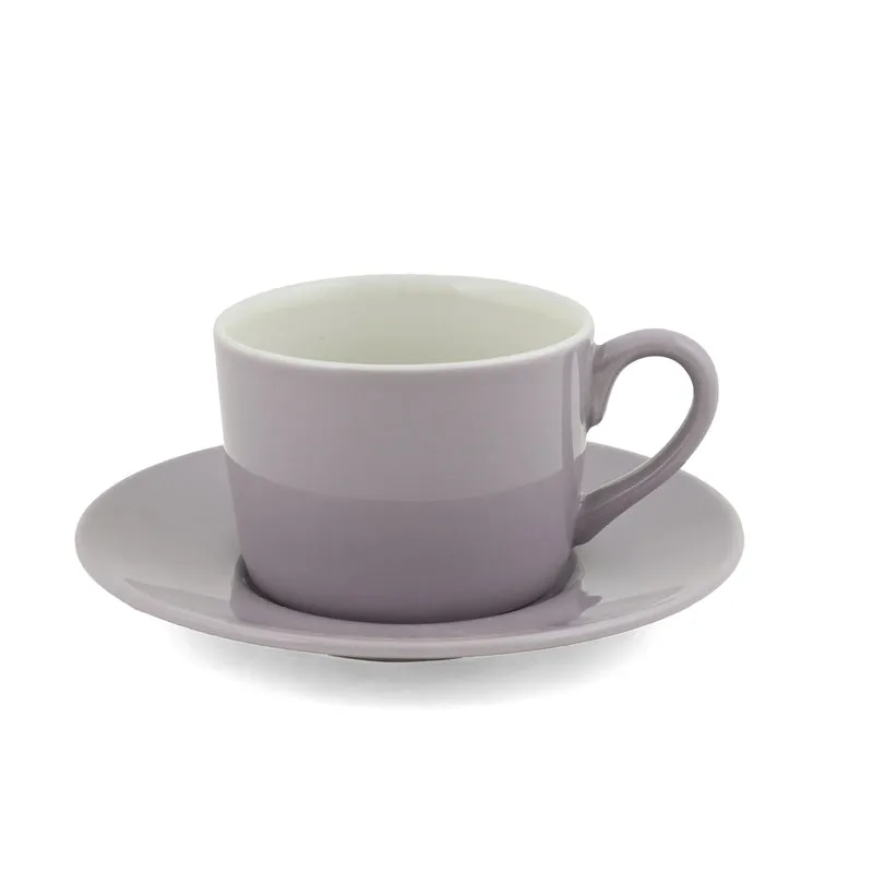 Single light purple cup and saucer on a white background