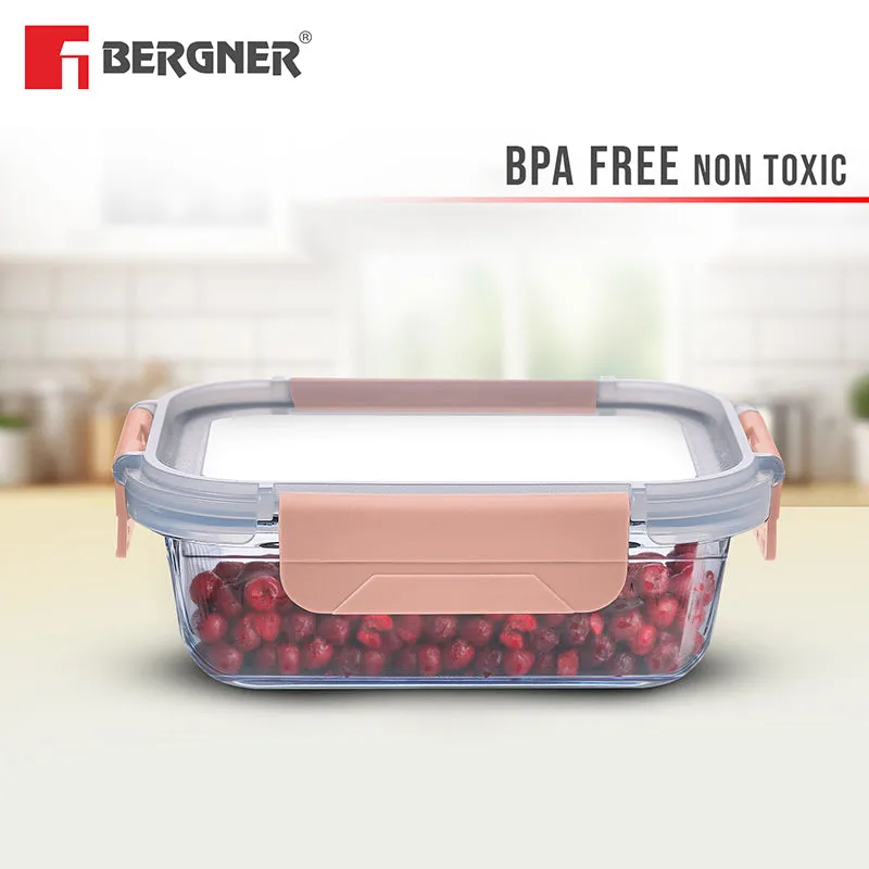 Transparent glass lunch box with peach lid shown against a bright kitchen background.