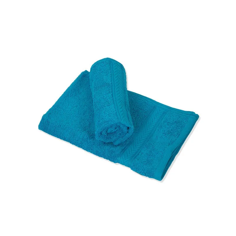 Rolled and folded blue hand towels on a white background