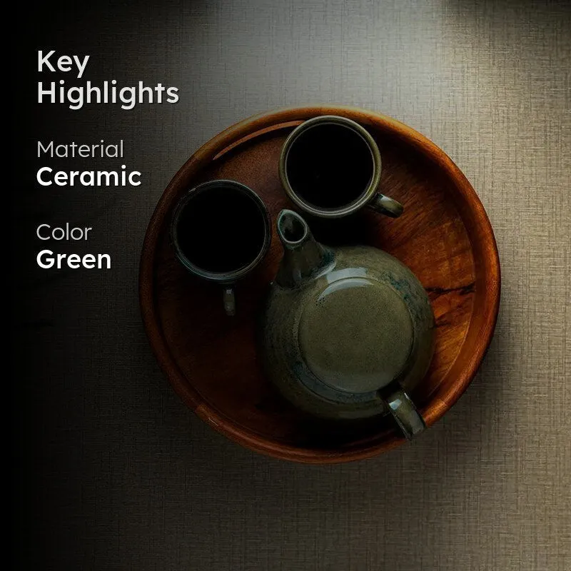 Green ceramic tea set arranged on a round wooden tray