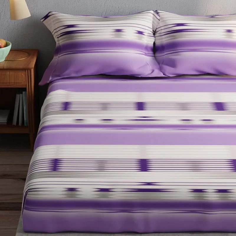 Close-up of purple and white abstract striped bedding with geometric accents