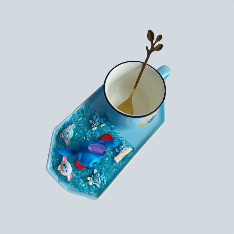 Top view of a blue character figurine, mug, spoon and textured tray