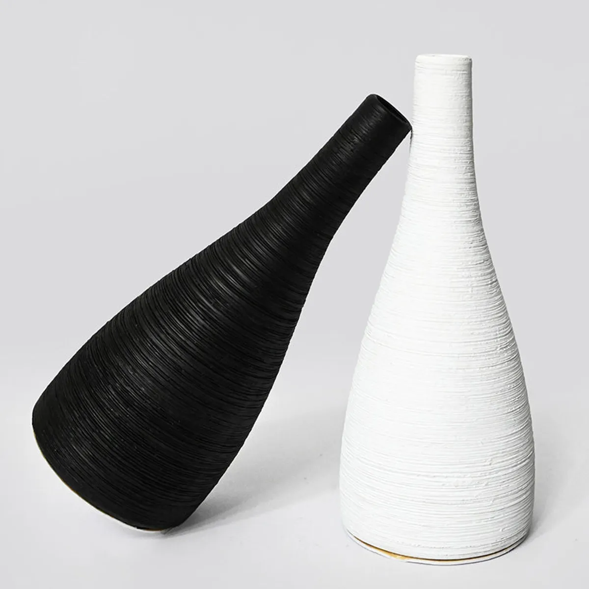 Black and white textured ceramic vases on a plain background
