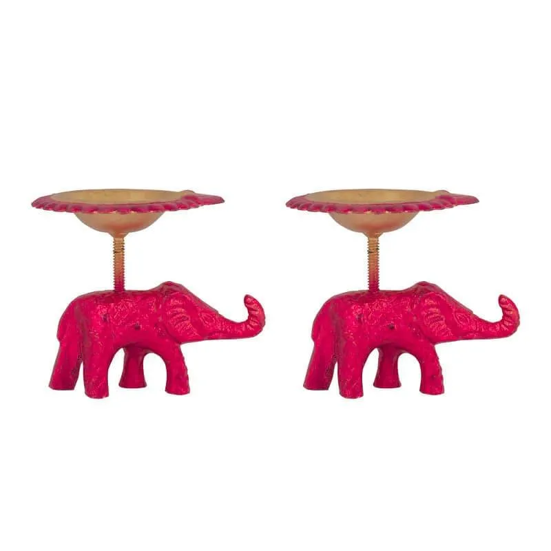 Pair of pink elephant tealight holders with gold-toned bowls on white background