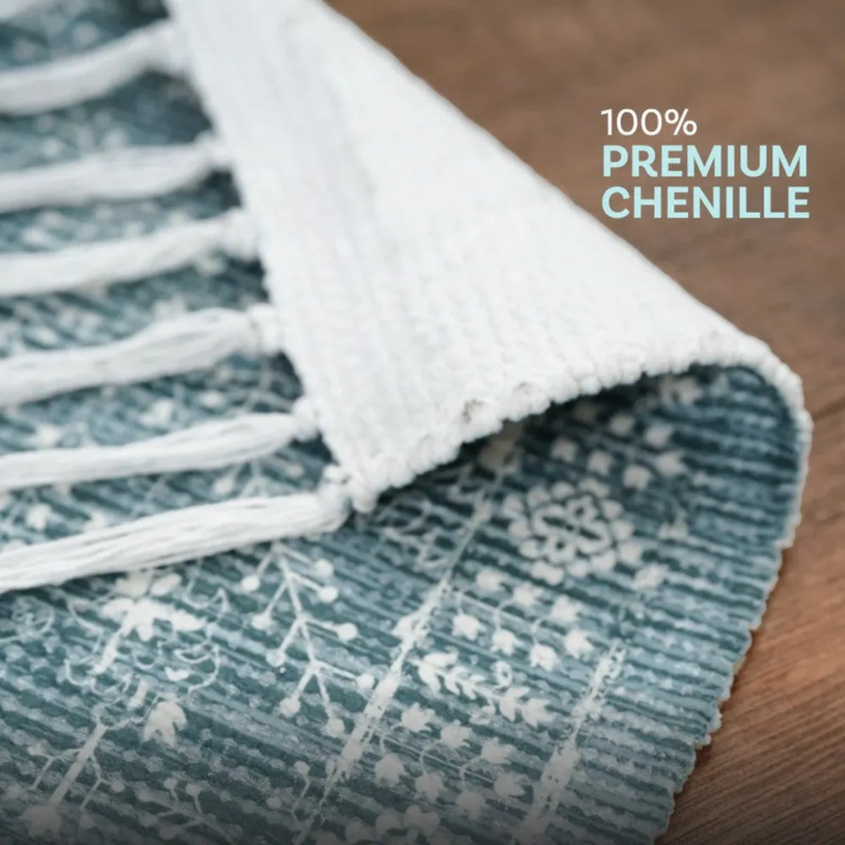 Folded corner of blue patterned runner rug with fringe detail
