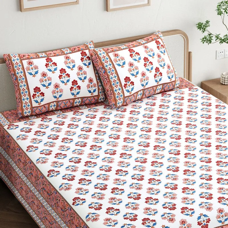 Close view of the floral bedsheet and matching pillow covers in maroon, blue and white