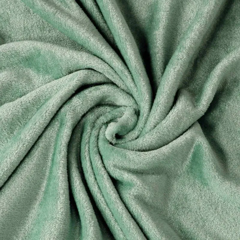 Close-up of soft sea green flannel fabric gathered in folds