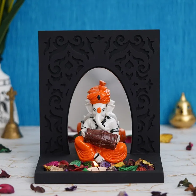 Front view of musical Ganesha tea light holder with black carved frame