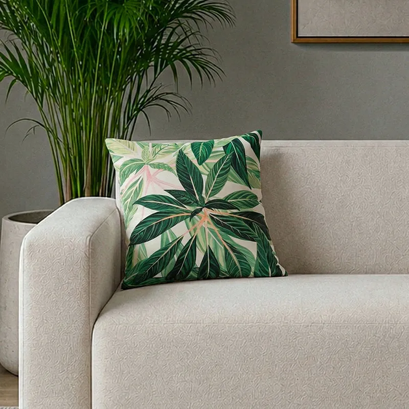 Tropical leaf print cushion cover styled on a light sofa