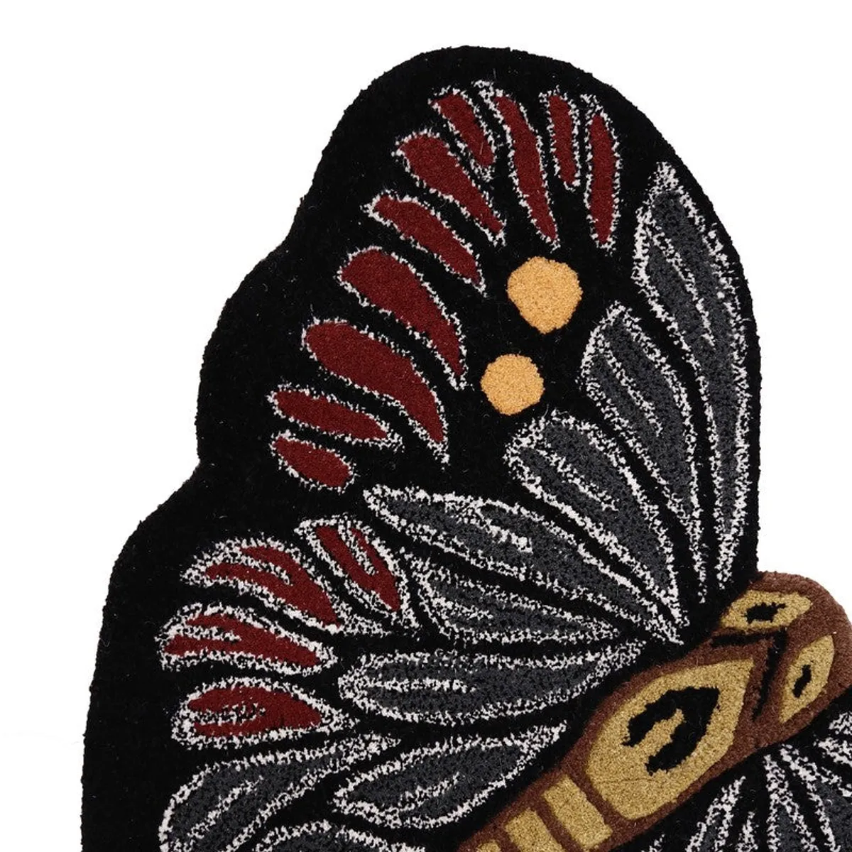 Close-up of red and grey geometric details on a butterfly carpet