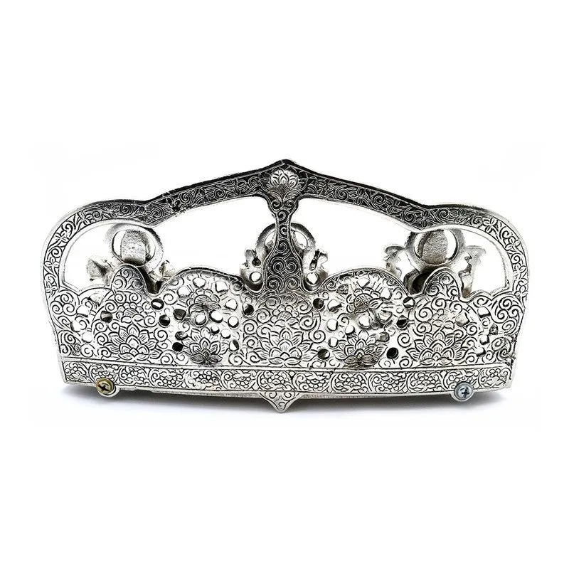 Back view of the ornate silver-toned metal idol