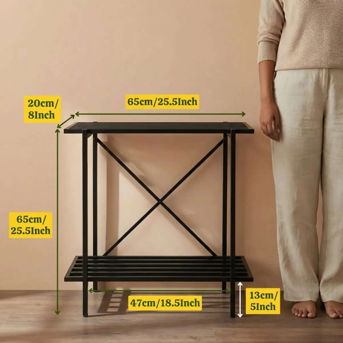 Black planter stand shown beside a person with dimension callouts