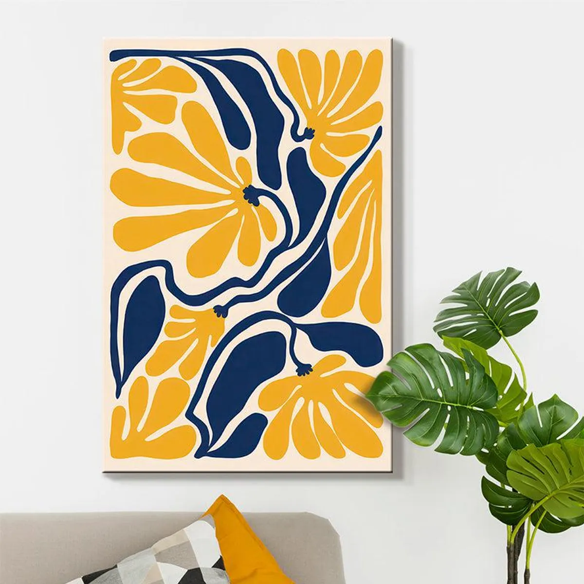 Yellow and blue floral canvas art styled above a sofa with green leaves