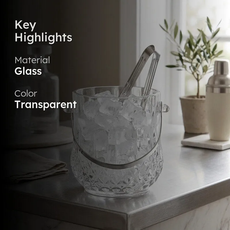 Glass ice bucket with metal handle and tongs in a styled setting