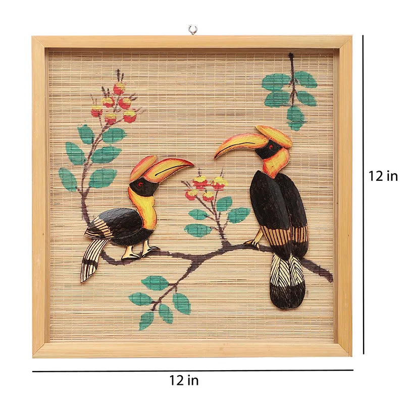 Front view of square toucan bamboo wall art with branch and foliage motif.