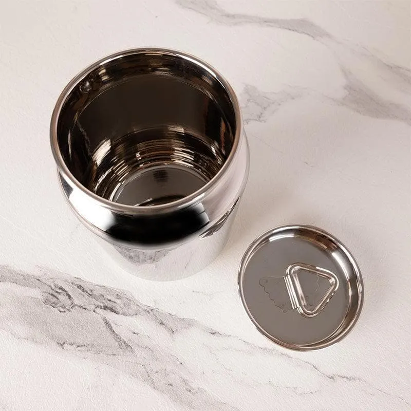 Top view of an open silver container and its handled lid