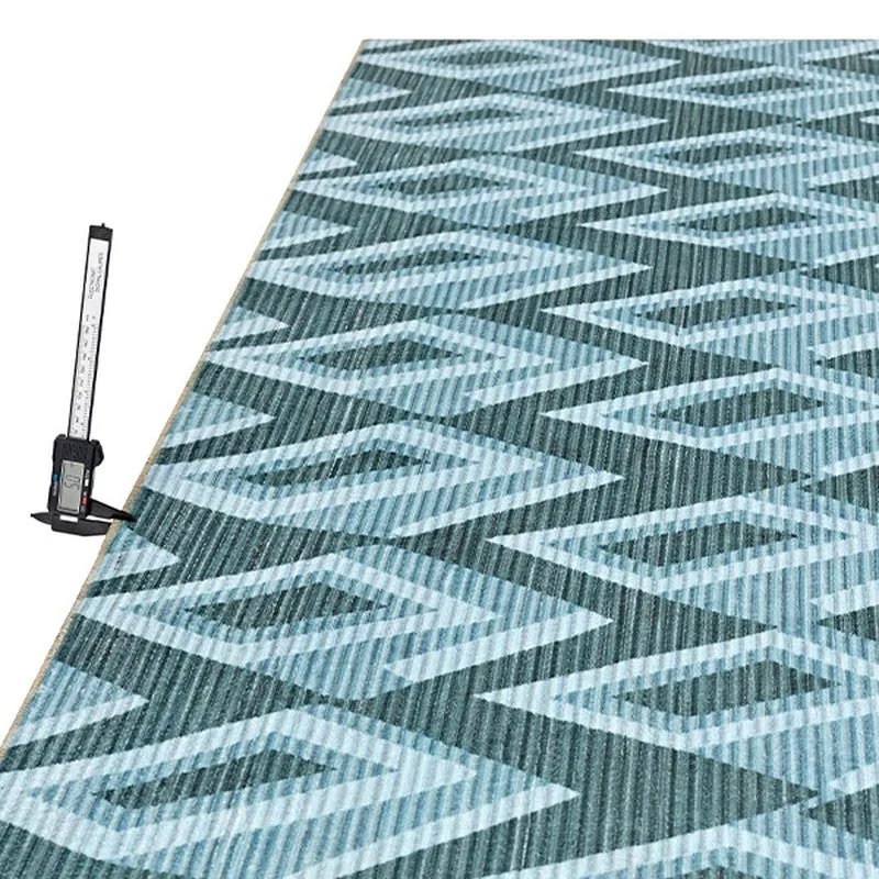 Angled view of blue geometric carpet with ribbed surface