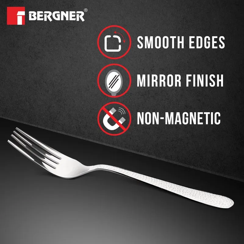 Silver fork with textured handle on a dark background