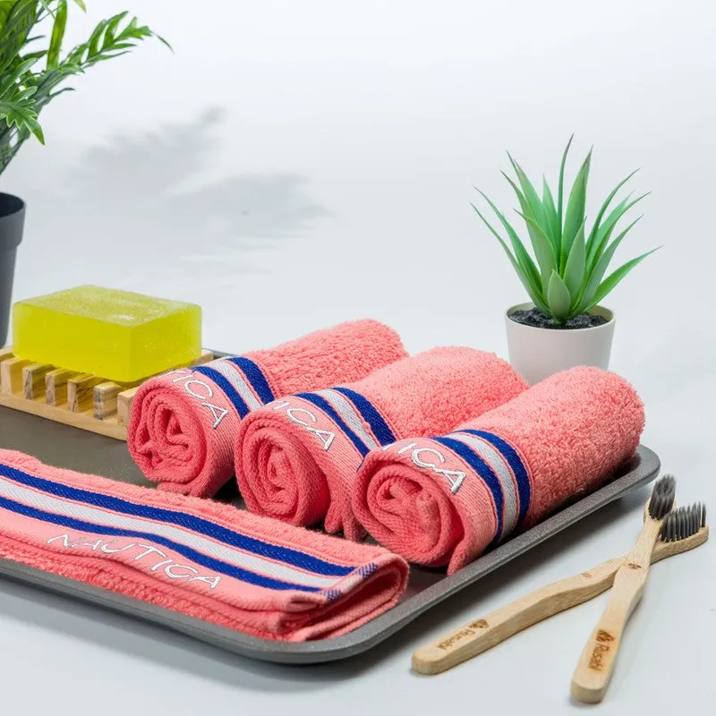 Four orange towels arranged on a tray with blue and white striped border