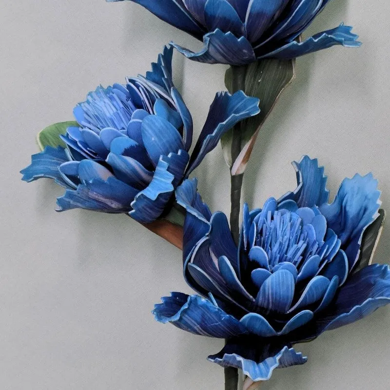 Detailed close-up showing layered blue petals on artificial dahlia flowers.