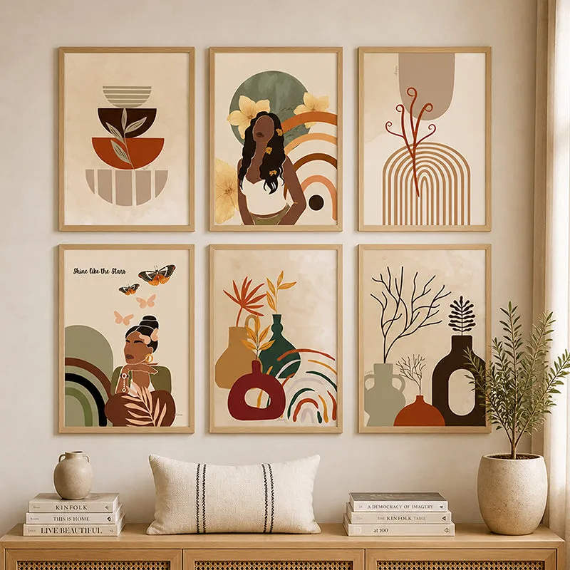 Symmetrical display of six framed wall art pieces above a console with decor