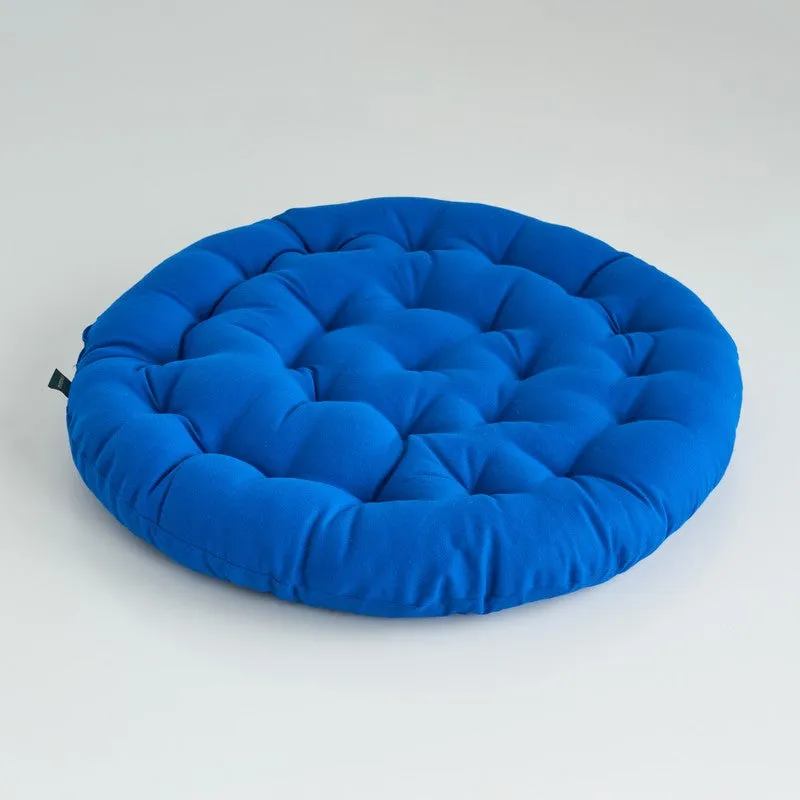 Single round blue floor cushion displayed against a light background.
