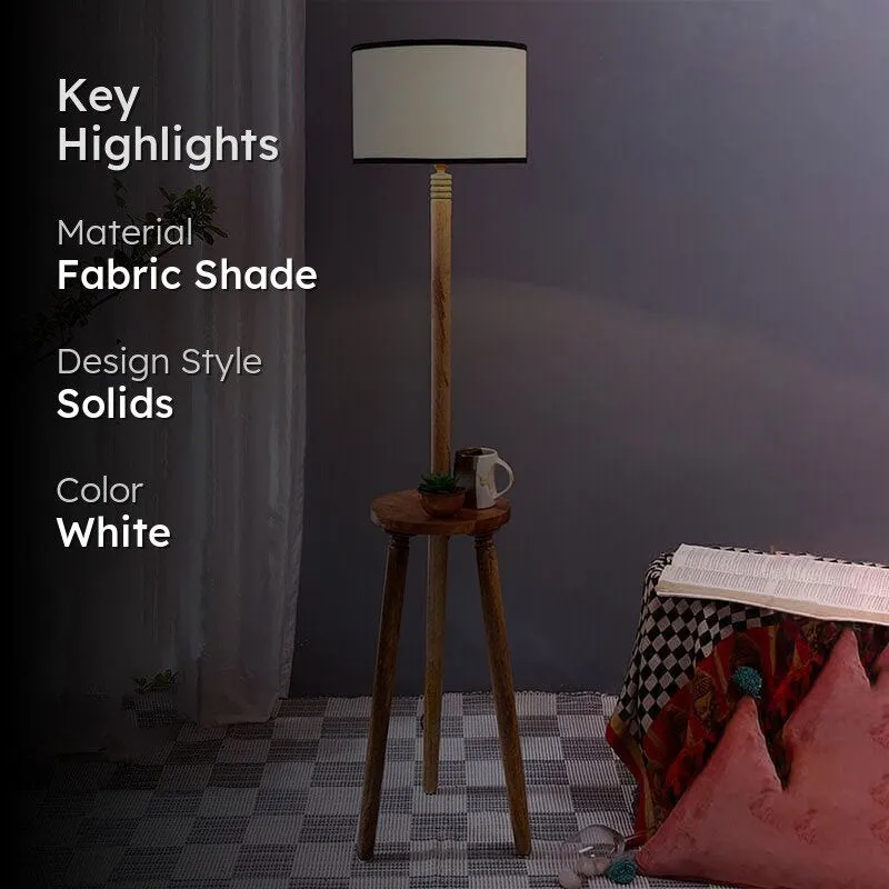 Wooden floor lamp with white shade shown in interior setting