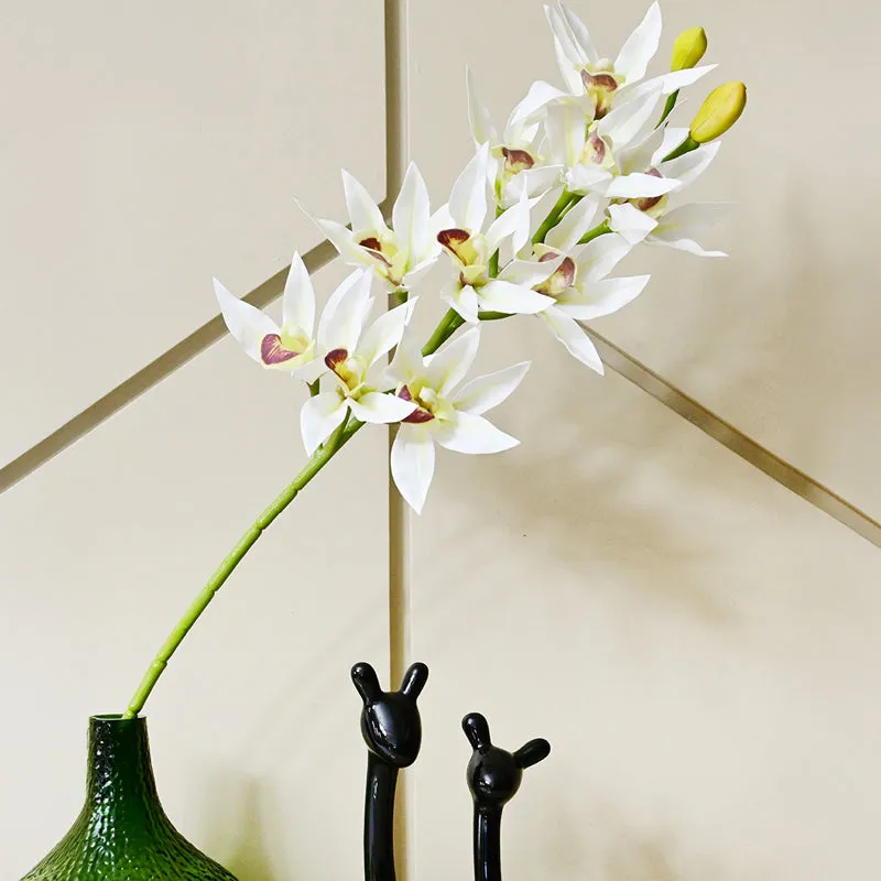Artificial white orchid flower stick displayed in a green vase