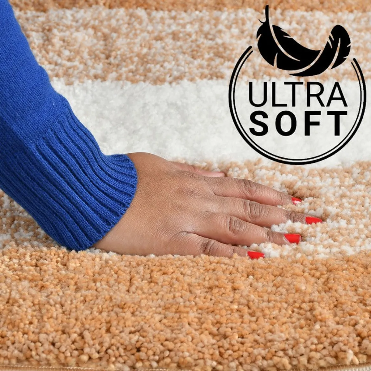 Close-up of a hand touching the soft textured rust and white bath mat