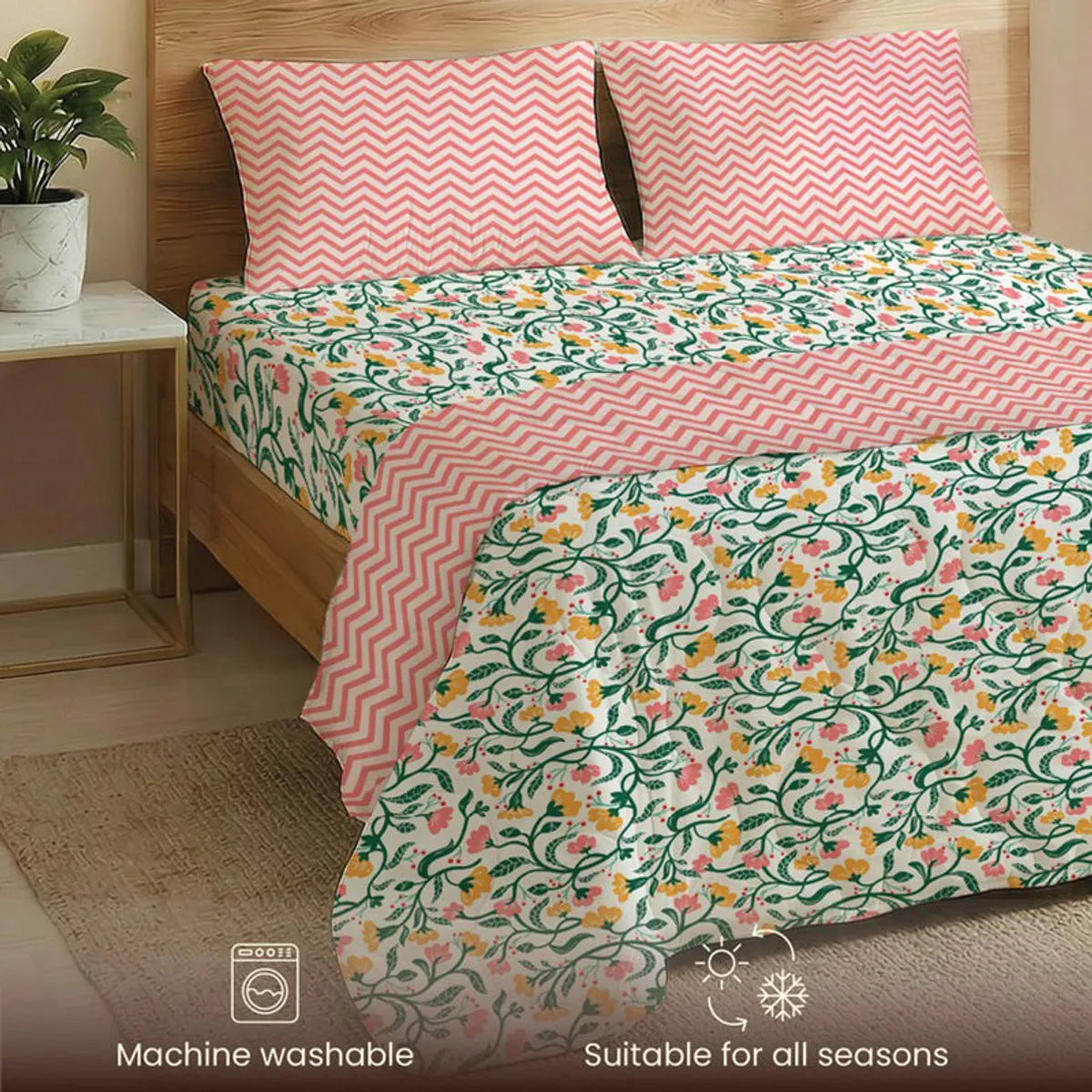 Angled view of floral bedding set with pink patterned reverse side