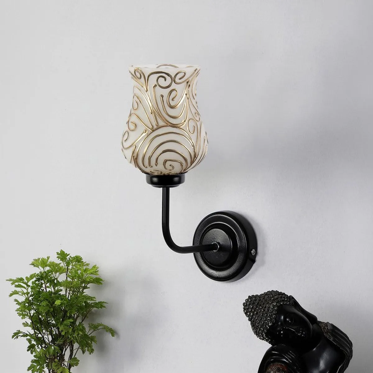 Close view of wall lamp with bell-shaped glass shade and black arm