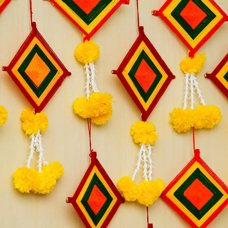 Close-up of multicolour fabric latkans with diamond pattern and yellow tassels