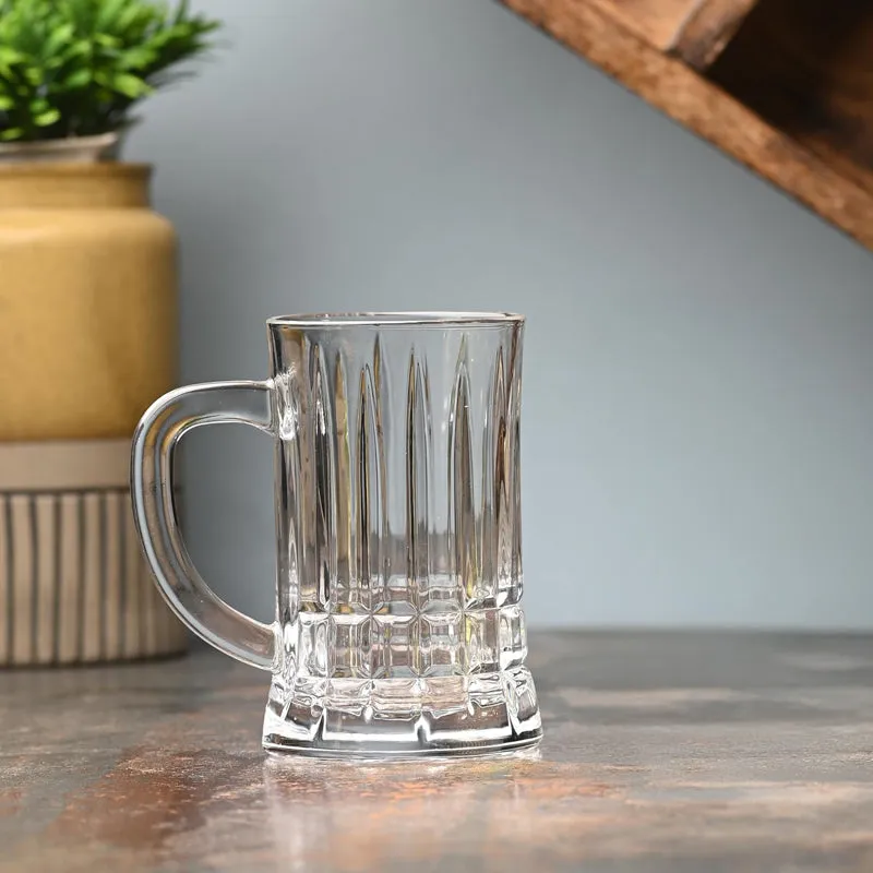 Single clear ribbed glass beer mug with a curved handle on a tabletop.