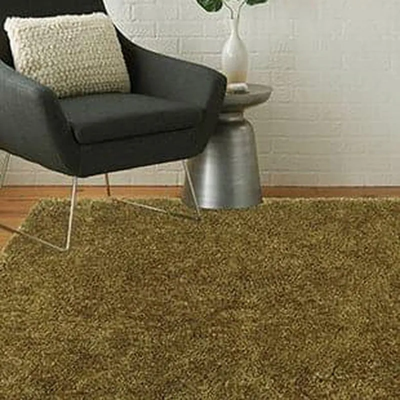 Olive-green shag rug styled beneath a black armchair in a living room