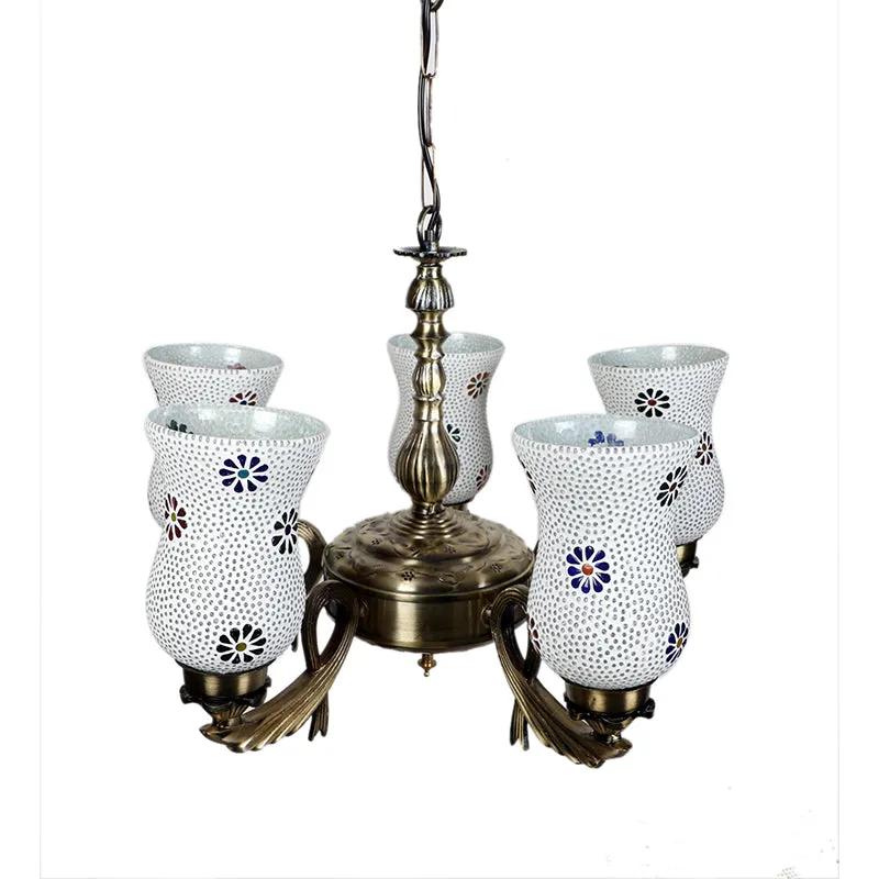 Close view of antique gold ceiling lamp with five white floral mosaic shades