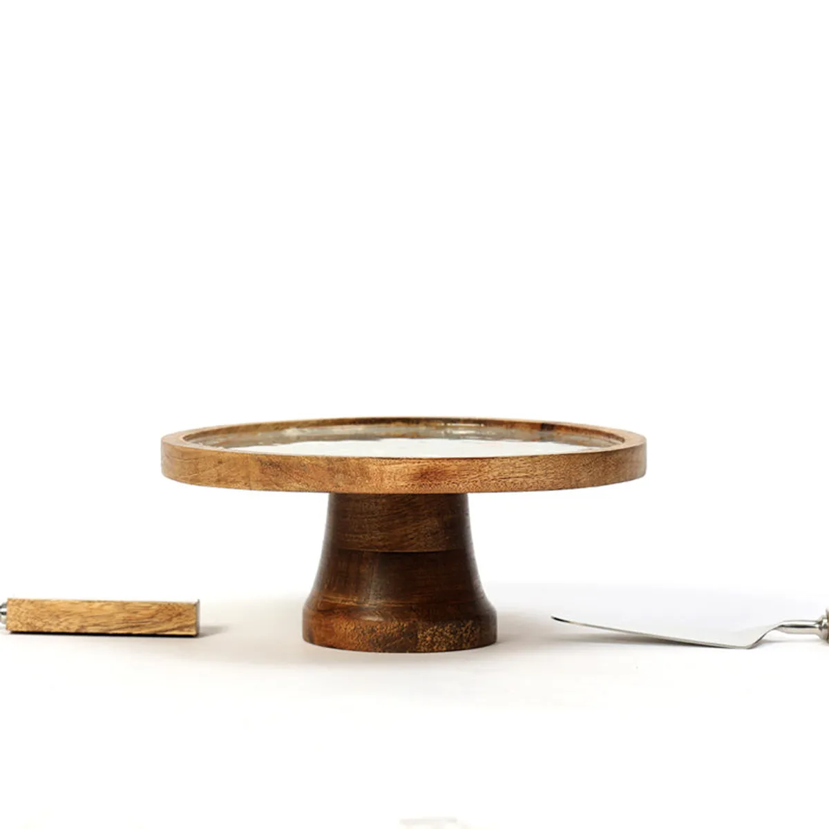 Side view showing the raised mango wood cake stand and serving tools