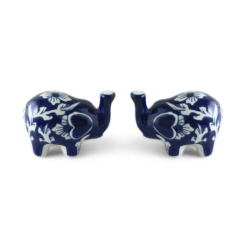 Two blue and white floral salt and pepper shakers on a white background