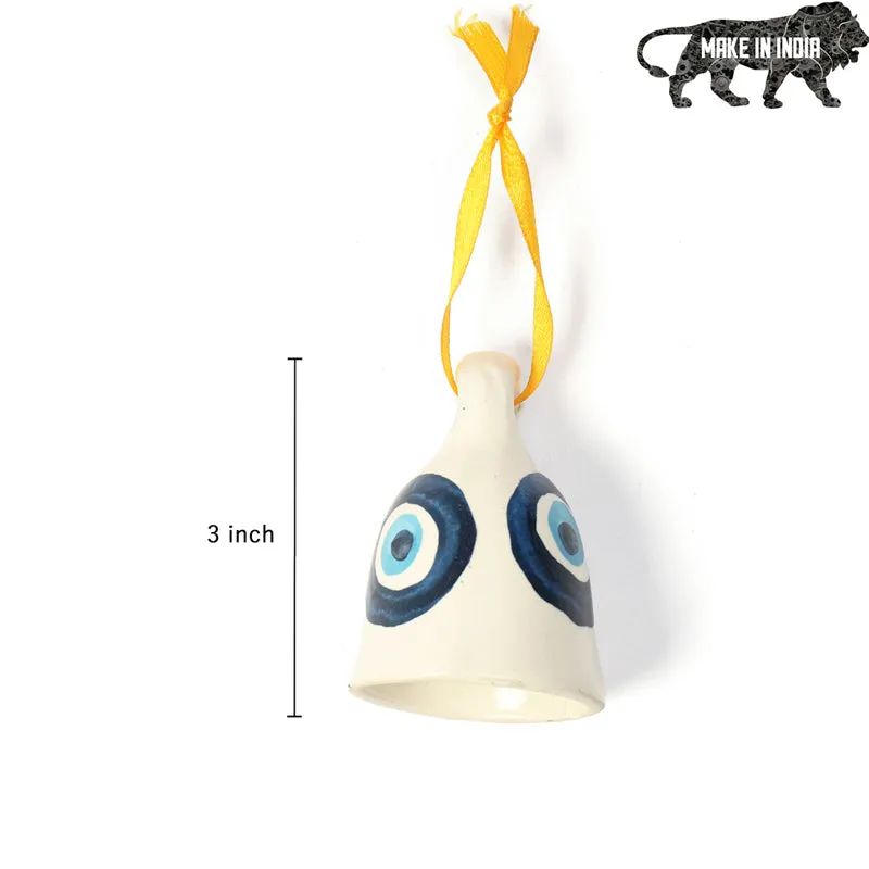 White ceramic evil eye hanging bell with yellow ribbon shown against a plain background
