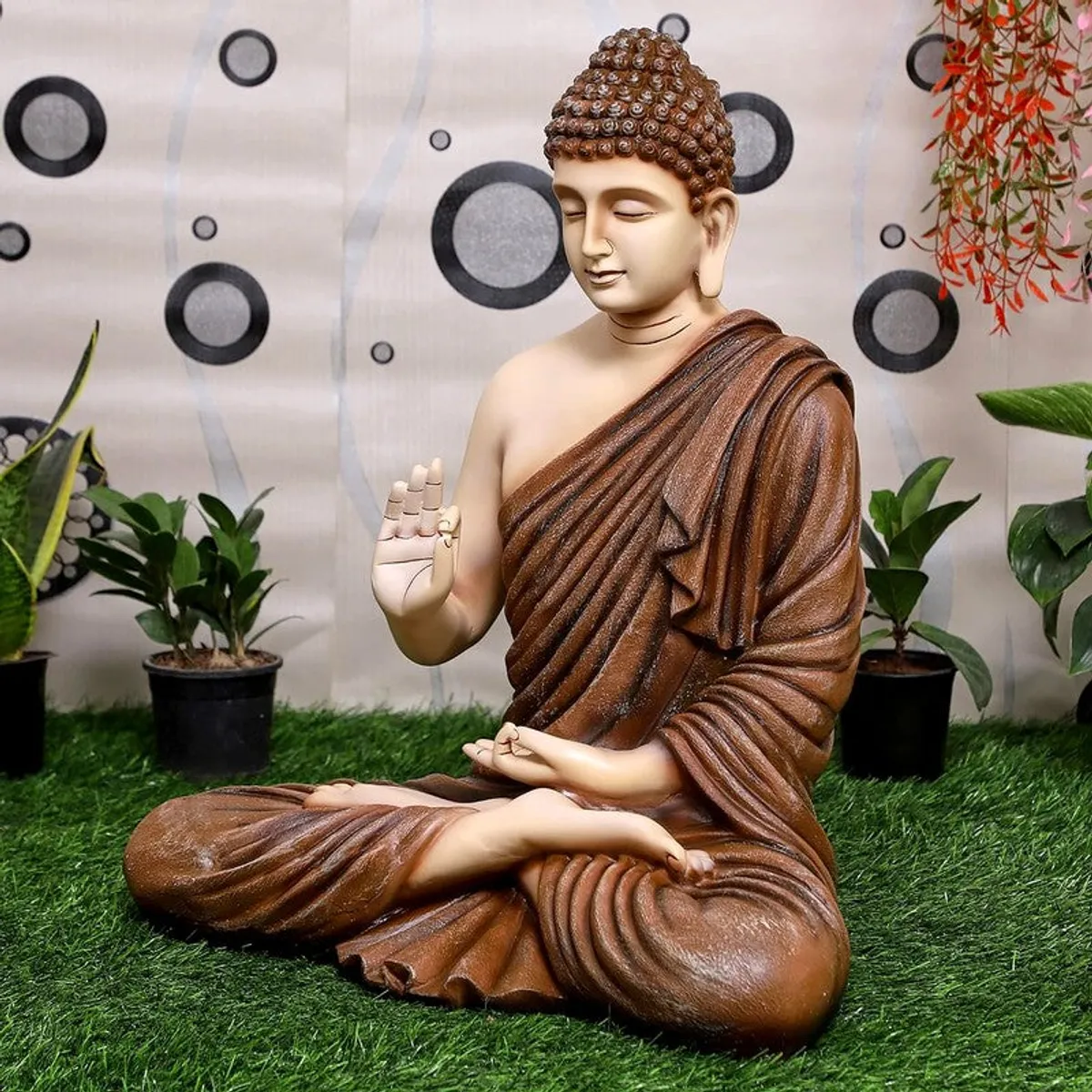 Angled view of brown and ivory Buddha showpiece with draped robe