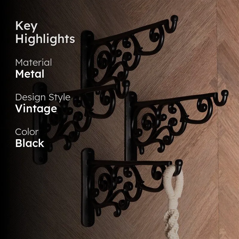 Four black vintage wall brackets displayed together with a hanging textile.